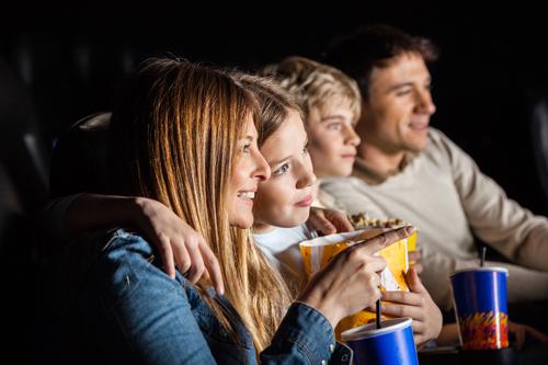 Family Of Four Watching Movie In Theater